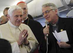 Pope Benedict XVI listens to Jesuit Father Federico Lombardi, the Vatican spokesman, inside a plane en route to Portugal May 11. The pope made some of his strongest remarks to date on the sex abuse cases during an in-flight press conference. Behind the p ope is Cardinal Tarcisio Bertone, Vatican secretary of state. (CNS photo/Stefano Rellandini, Reuters)