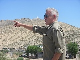 Columban Father Kevin Mullins, pastor of Corpus Christi Church outside of Ciudad Juarez, Mexico, points to the open field behind his church Sept. 16 where he hopes to build a youth center to prevent the young in his parish from being attracted to the lure of the cartels. Two of his former confirmation class students were stoned to death in this field. (CNS photo/Joseph Kolb) (Oct. 5, 2011)