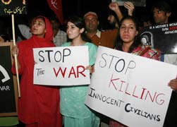 In this 2008 file photo, students and peace activists in Lahore, Pakistan carry signs for peace during a protest against U.S. military strikes in Pakistan's tribal areas along the Afghanistan border. (CNS/Reuters)