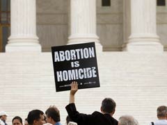 A pro-life demonstrator holds up a placard outside the U.S. Supreme Court in Washington in October 2008. (CNS/Reuters/Kevin Lamarque)