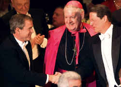 Then Republican presidential candidate Texas Gov. George W. Bush (left) and then Democratic presidential candidate Vice President Al Gore shake hands while New York Archbishop Edward M. Egan looks on at the annual Alfred E. Smith Memorial Foundation Dinner in New York Oct. 19. (CNS photo from Reuters)