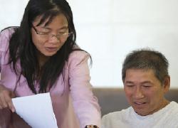 Mai Quach, director of employment programs for Lao Family Community Development, works with a client. (Photos by Breck Sargent)