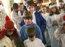The cast of the Christmas play "An Angel for the King" prays before rehearsal at St. John the Baptist Parish in Larksville, Pa., in 2006. (Courtesy of the Times Leader/Charlotte Bartizek)