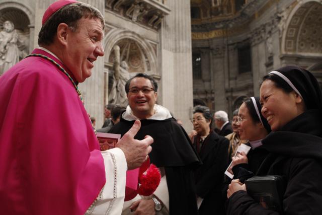 Archbishop Joseph W. Tobin, secretary of the Vatican's Congregation for Institutes of Consecrated Life and Societies of Apostolic Life, talks with religious in St. Peter's Basilica Feb. 2, the World Day for Consecrated Life. (CNS/Paul Haring)