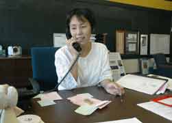 Sr. Anji Fan, a native of China and a member of the Sisters of Providence of St. Mary-of-the-Woods, Ind., answers the phone in 2007 at Providence Cristo Rey High School in Indianapolis, where she volunteered during the summer. (CNS photo/Sean Gallagher)