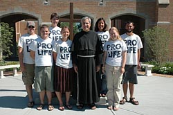 Posing for a group picture in Indianapolis are Crossroads Pro-Life Walk Across America participants, from left, Jason Spoolstra of Fort Worth, Texas; Jason Handcock of Sacramento, Calif.; Beth Ann Flessner of Madison, Miss.; Tina Hardy of Buffalo, N.Y.; Franciscan Fr. Dan Pattee of Steubenville, Ohio; Cassandra Blanco of Deltona, Fla.; Alzbeta Voboril of Wichita, Kan.; and William Tolsma of Niles, Mich. (CNS/The Criterion/Mary Ann Wyand)