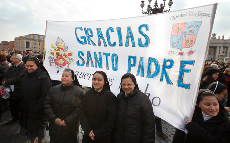 Nuns hold a banner thanking Pope Benedict XVI before he delivers the Angelus from the window of his apartment overlooking St. Peter’s Square at the Vatican Feb. 17. (CNS/Paul Haring)