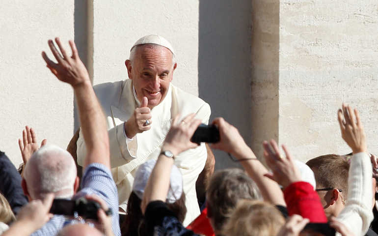 Pope Francis greets a crowd in St. Peter's Square with a thumbs up March 2. (CNS/Paul Haring)
