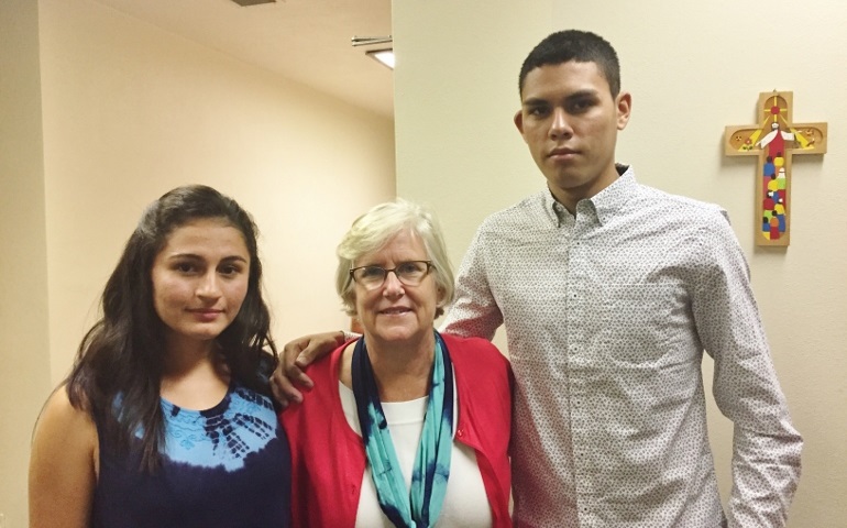 From left, Gregoria Leonor Acevedo Huezo, Leslie Schuld and Ernesto Josue Henriquez Joachin at St. Elizabeth Parish in Kansas City, Mo., on Oct. 22 (NCR photo/Traci Badalucco)