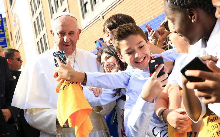 Students take "selfie" pictures with Pope Francis outside in the East Harlem Sept. 25. (CNS photo/Eric Thayer, pool) 