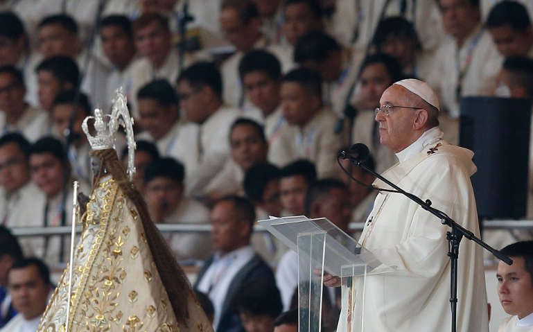 Pope Francis gives the homily while celebrating Mass at Rizal Park in Manila, Philippines, Jan. 18 with statue of Santo Nino in forground. (CNS/Paul Haring)