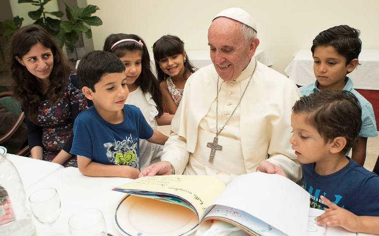 Pope Francis with Syrian refugee children at a Vatican lunch Aug. 11. (CNS photo/L'Osservatore Romano via Reuters)
