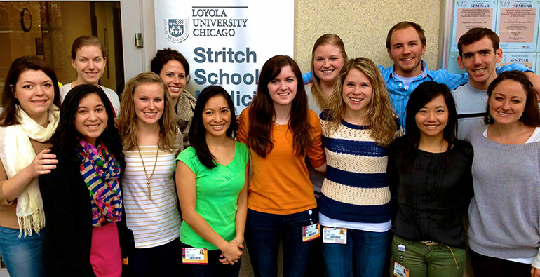 Students who are part of the first class of the Physician's Vocation Program pose in front of Loyola University Chicago's Stritch School of Medicine. (Jenna Janiga)