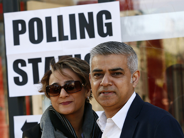 Sadiq Khan, Britain's Labour Party candidate for mayor of London, and his wife, Saadiya, pose for photographers after casting their votes in the race May 5, 2016. (Reuters/Stefan Wermuth)