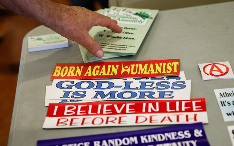An attendee grabs a brochure at the Sunday Assembly, an atheist congregation in Los Angeles in November 2013. (AP photo/Jae C. Hong)