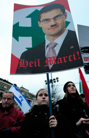 A young girl holds a placard at a demonstration against Hungarian far-right politician Marton Gyongyosi during a demonstration in front of the parliament building in Budapest on Dec. 2. Gyongyosi had called on the government to draw up lists of Jews who pose a “national security risk.” (AFP/Attila Kisbenedekattila)