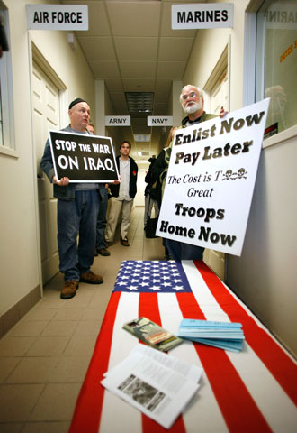 Edward Bloomer, left, and Frank Cordaro, right, stand outside recruiting offices during a March 2008 protest at the Armed Forces Career Center in Des Moines, Iowa. (AP/Charlie Neibergall)