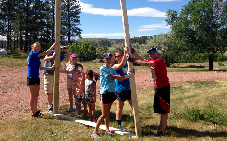 Members of a Catholic HEART Workcamp team build a shed in Lame Deer, Mont., on the Northern Cheyenne Reservation on July 13. The project was completed at the home of Francis and Vonda Limpy, who are Northern Cheyenne tribal elders. (Courtesy of Annie Nassis)