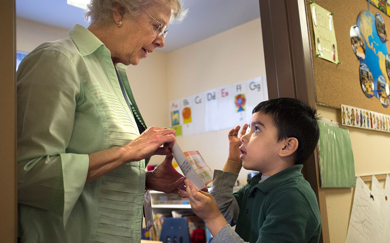 Most Precious Blood Sr. Joyce Schramm works with Holy Trinity Catholc School kindergarten student William Nieto Nov. 13 as part of the English as a Second Language program at the school in St. Ann, Mo. (CNS/St. Louis Review/Sid Hastings)