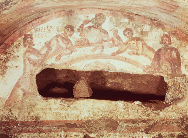 A eucharistic meal is depicted in a third-century mural in the Catacombs of Sts. Marcellinus and Peter in Rome. (Newscom/KG-images/André Held)