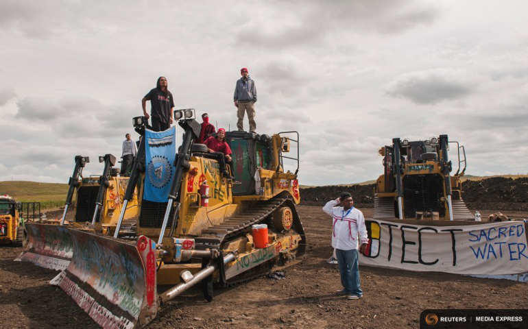 Protesters stand on heavy machinery after halting work on the Energy Transfer Partners Dakota Access pipeline near the Standing Rock Sious reservation in North Dakota Sept. 6. (Rueters/Andrew Cullen)