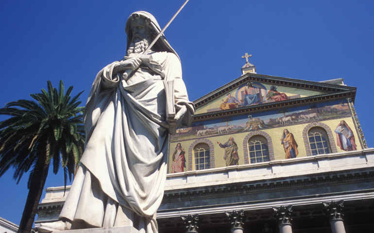 A statue of St. Paul with Rome's Basilica of St. Paul Outside the Walls in the background. (CNS/Paul Haring)