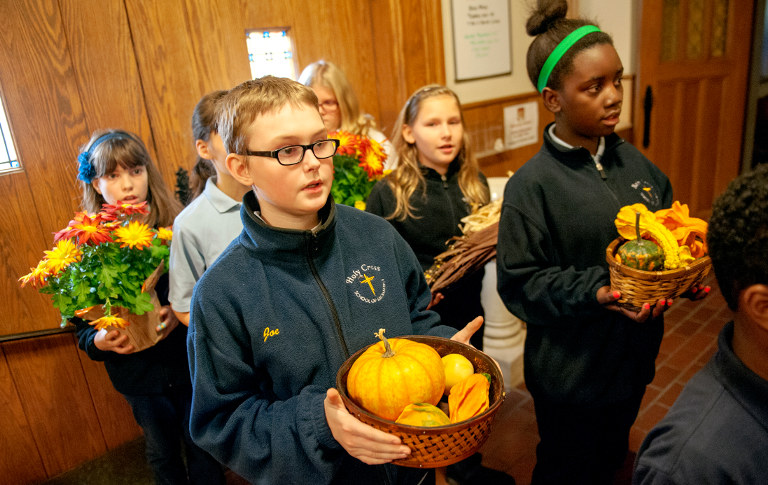 Holy Cross School fifth-graders take Thanksgiving offerings to the altar during a Nov. 24 Thanksgiving Mass at Holy Cross Church in Rochester, N.Y. (CNS/Mike Crupi)