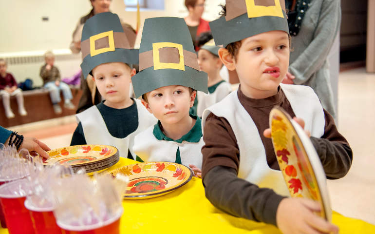 Ben McFiggins, right, and Robbie Shumaker, center, join other kindergartners in line for a feast Nov. 20 during a Thanksgiving celebration at St. Patrick School in Owego, N.Y. (CNS photo/Mike Crupi, Catholic Courier)