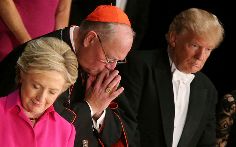 Hillary Clinton, Archbishop of New York Cardinal Timothy Dolan and Donald Trump pray as they attend the Alfred E. Smith Memorial Foundation dinner to benefit Catholic charities in New York. (Photo courtesy of Reuters/Carlos Barr)