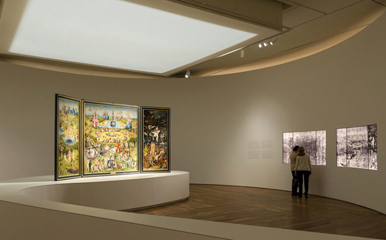 Installation view of “Bosch: The 5th Centenary Exhibition,” with “The Garden of Earthly Delights” on the left and X-radiographs of the painting on the right, in the Museo Nacional del Prado in Madrid. (Museo Nacional del Prado)
