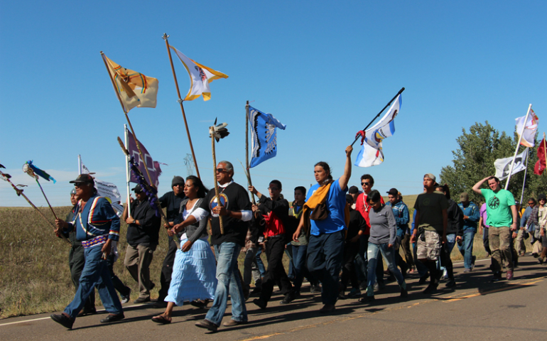 Several hundred people take part in a prayer walk on Sept. 14, 2016, from the Oceti Sakowin camp near Standing Rock Reservation in North Dakota to the site up the road where Dakota Access began digging over Labor Day weekend for construction on a nearly 1,200-mile pipeline project. (RNS/Emily McFarlan Miller)