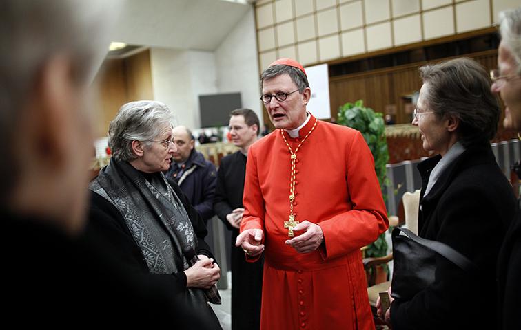 Cardinal Rainer Maria Woelki of Germany receives guests in the Paul VI Hall at the Vatican on Feb. 18, 2012. (Reuters/Tony Gentile)