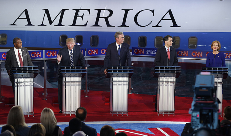 Republican U.S. presidential candidate Dr. Ben Carson, left, watches businessman Donald Trump, second left, criticize the business record of former HP CEO Carly Fiorina, far right, as former Florida Gov. Jeb Bush, center. Wisconsin Gov. Scott Walker, who dropped out of the race not long after the debate, here looks over to Fiorina during the second official Republican presidential candidates debate of the 2016 U.S. presidential campaign at the Ronald Reagan Presidential Library in Simi Valley, Calif., on S