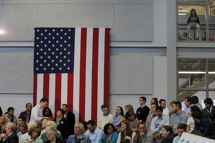 A girl, top right, sits above a campaign town hall meeting with Democratic presidential candidate Hillary Clinton in Manchester, N.H., on Oct. 5, 2015. (Reuters/Brian Snyder)