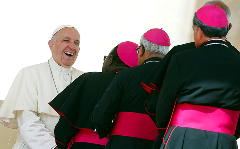 Pope Francis smiles Sept. 7 as he greets bishops at the Vatican. (Reuters/Remo Casilli)
