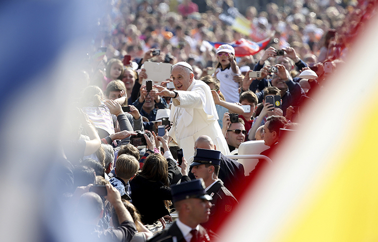 Pope Francis waves as he arrives to lead the general audience in St. Peter’s Square at the Vatican on April 15, 2015. (Reuters/Alessandro Bianchi)