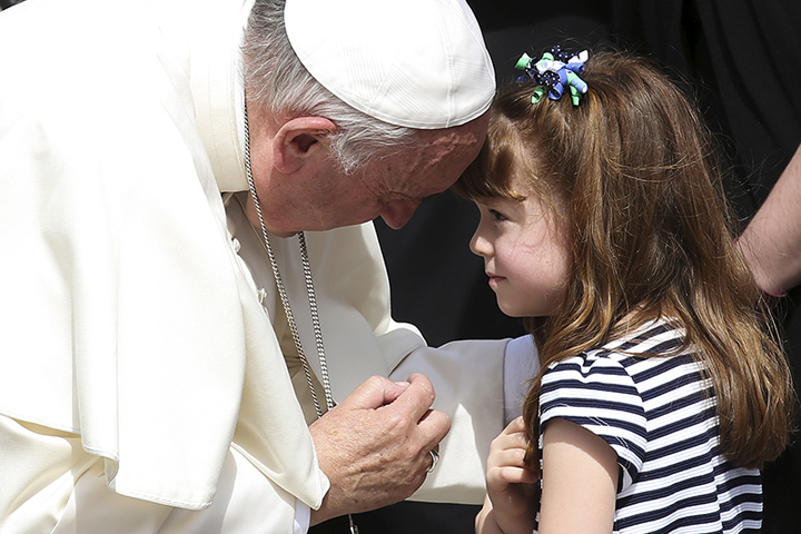 Pope Francis speaks to Elizabeth “Lizzy” Myers, a 5-year-old girl from Ohio who suffers from a genetic disease known as Usher syndrome, which leads to blindness and hearing loss, at the end of the weekly audience in St. Peter’s Square at the Vatican on April 6, 2016. (Reuters/Alessandro Bianchi)