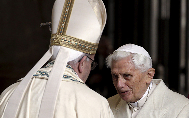 Pope Francis, left, meets Emeritus Pope Benedict XVI before opening the Holy Door to mark the opening of the Catholic Holy Year, or Jubilee, in St. Peter's Basilica, at the Vatican, on Dec. 8, 2015. (Reuters/Max Rossi)