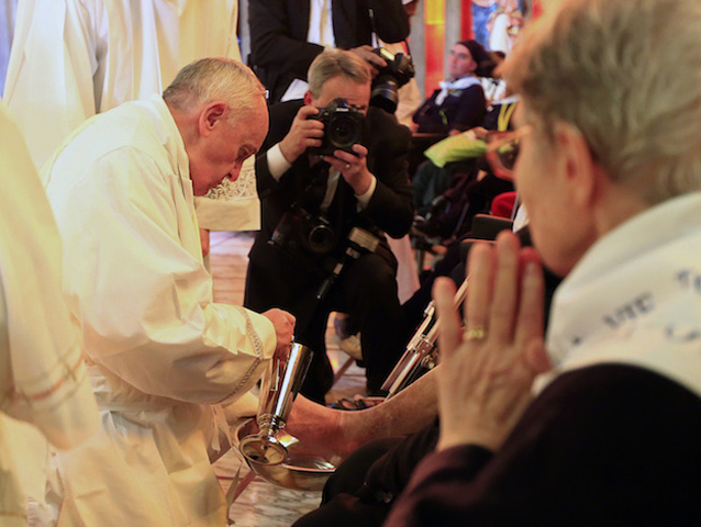 Pope Francis washes a foot of a disabled person at the S. Maria della Provvidenza church in Rome, during the Holy Thursday celebration, on April 17, 2014. (Reuters/Tony Gentile)
