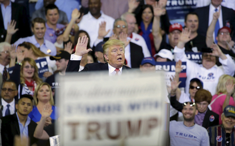 Presidential candidate Donald Trump asks supporters to raise their hands and promise to vote for him at a campaign rally March 5, 2016, in Orlando, Fla. (RNS/Reuters/Kevin Kolczynski)