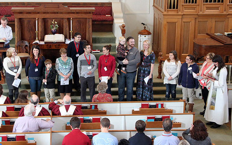 Pastor Robin Bartlett, far right, conducts a new-member ceremony at First Church in Sterling, Mass. (Matt Lucarelli, courtesy of First Church)