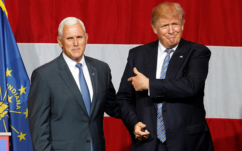 Indiana Gov. Mike Pence, left, and Republican presidential candidate Donald Trump wave to the crowd during a campaign stop at the Grand Park Events Center in Westfield, Ind., on July 12, 2016. (Photo courtesy of Reuters/John Sommers II)