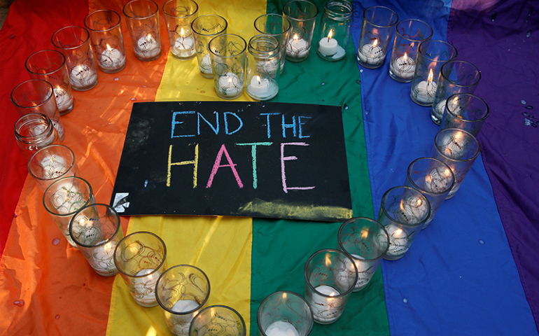 University of the Philippines students display glasses with lit candles and a placard as a tribute to those killed in the Pulse nightclub mass shooting in Orlando, Fla., during a protest at the school campus in Quezon city, Metro Manila, on June 14, 2016. (REUTERS/Erik De Castro)