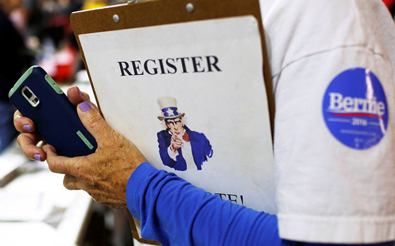 A volunteer staffs a voter registration table before U.S. Democratic presidential candidate Bernie Sanders held a campaign rally in New Brunswick, N.J., on May 8, 2016. (Photo courtesy of REUTERS/Dominick Reuter)