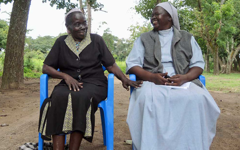 Angelika Ouma, left, the director of the Bishop Caesar Asili Memorial Nursery and Primary School, and head teacher Sr. Laura Kaneyo sit outside the school, overseeing an expansion that will enable them to open an additional classroom. (GSR photo / Melanie Lidman)