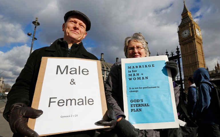 Christian activists Jonathan Longstaff and Jenny Rose, both from London, protest outside Parliament. Feb. 5 members of Britain's House of Commons voted, 400-175, to allow same-sex marriage, pushing a controversial piece of legislation closer to becoming law. The vote followed six hours of debate. (CNS photo/Chris Helgren, Reuters)