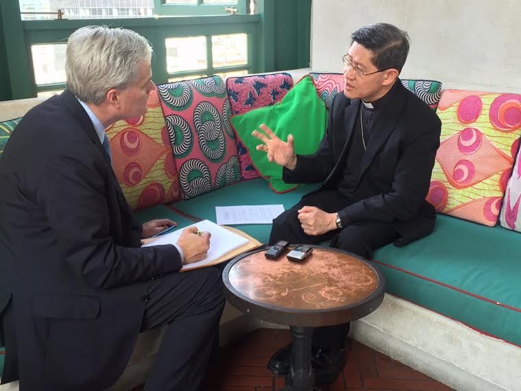 NCR's Tom Gallagher, left, talks to Philippines Cardinal Luis Antonio Tagle in the lobby of a hotel in midtown Manhattan. (Courtesy of Caritas Internationalis)