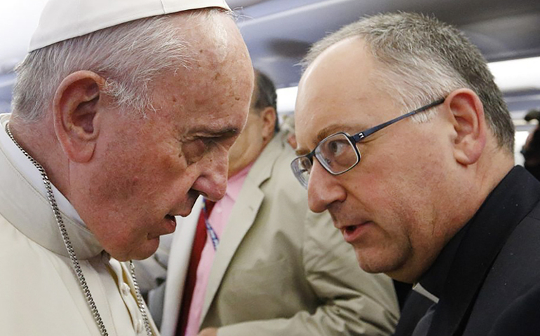 Pope Francis talks with Jesuit Father Antonio Spadaro, editor of La Civiltà Cattolica, as he meets journalists aboard his flight from Rome to Nairobi, Kenya, on Nov. 25, 2015. (CNS / Paul Haring)