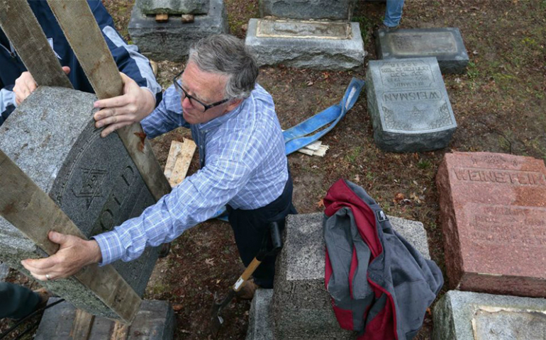 Philip Weiss of Rosenbloom Monument Co. resets headstones at Chesed Shel Emeth Cemetery in University City, Mo., on Feb. 21, 2017, after almost 200 gravestones were vandalized over the weekend. (Robert Cohen/St. Louis Post-Dispatch)