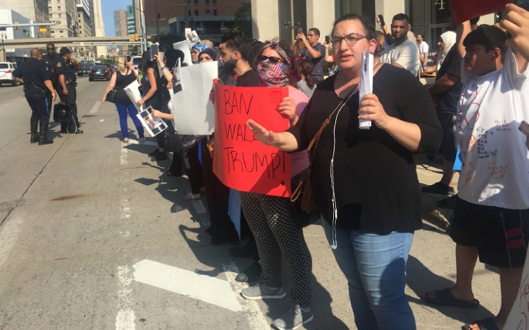 Protesters in front of the McNamara Federal Building in Detroit, Michigan, chant "Stop deportations, bring our families home" on June 14, 2017. (Courtesy of the Detroit Free Press/Allie Gross)
